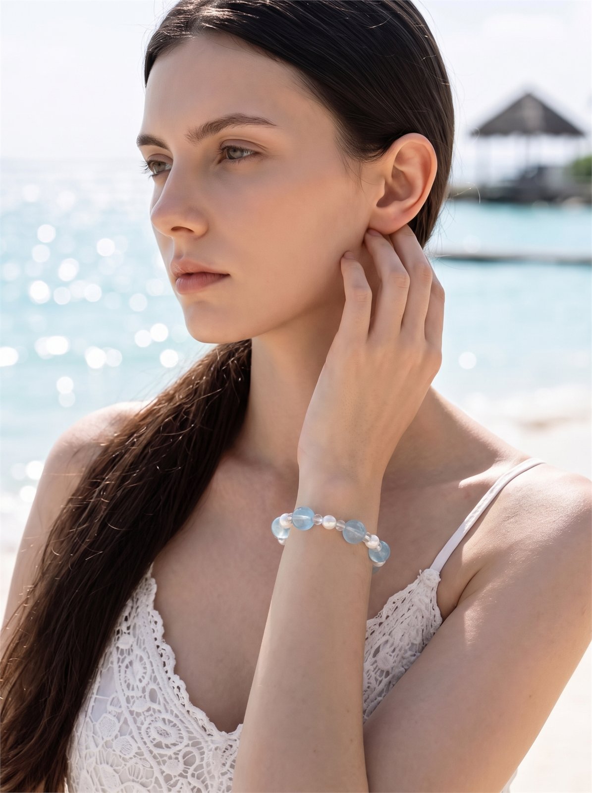Model wearing a Ripples Jewelry bracelet by the sea